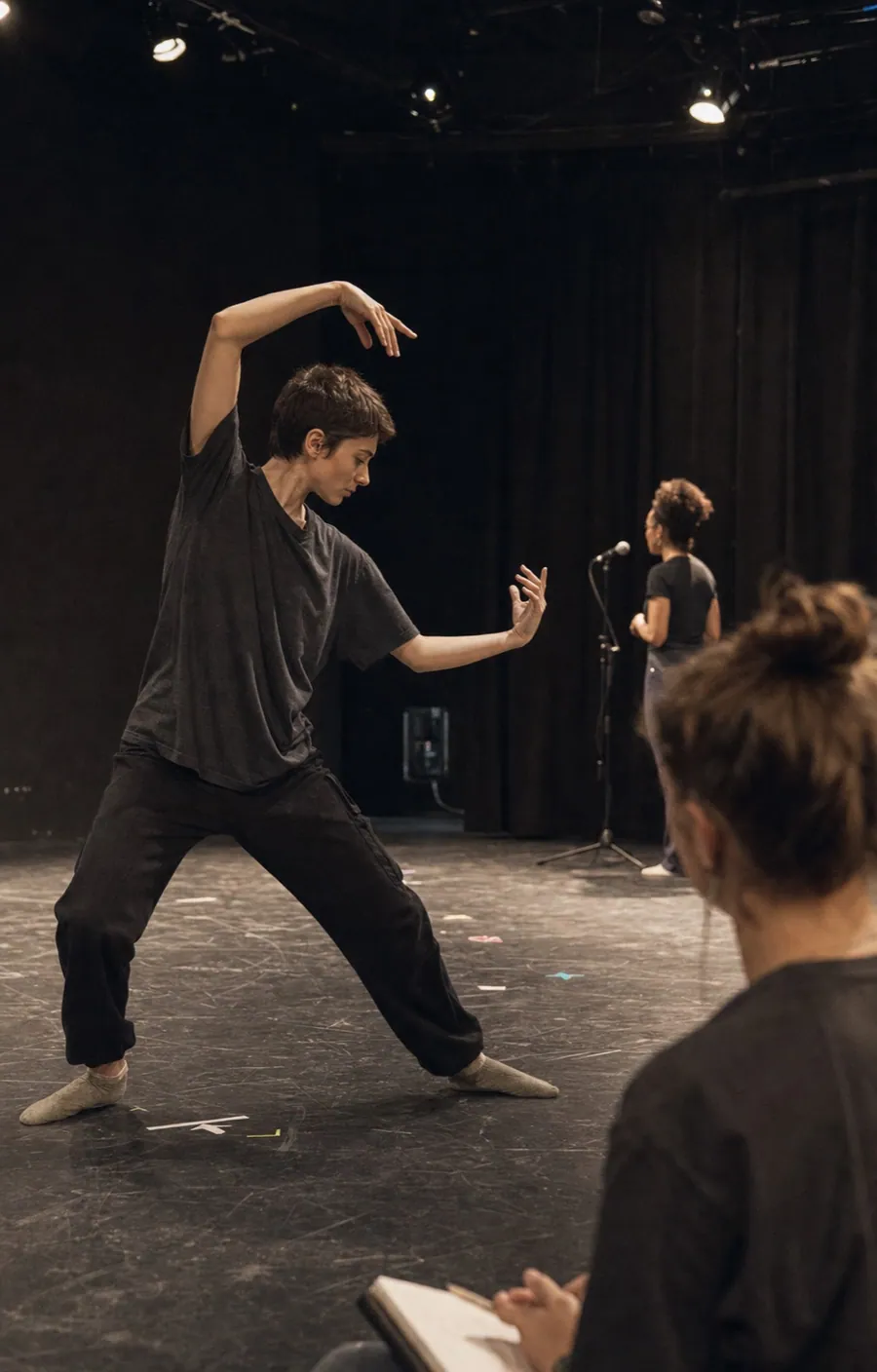Performers developing movement, voice and staging during a theatre rehearsal